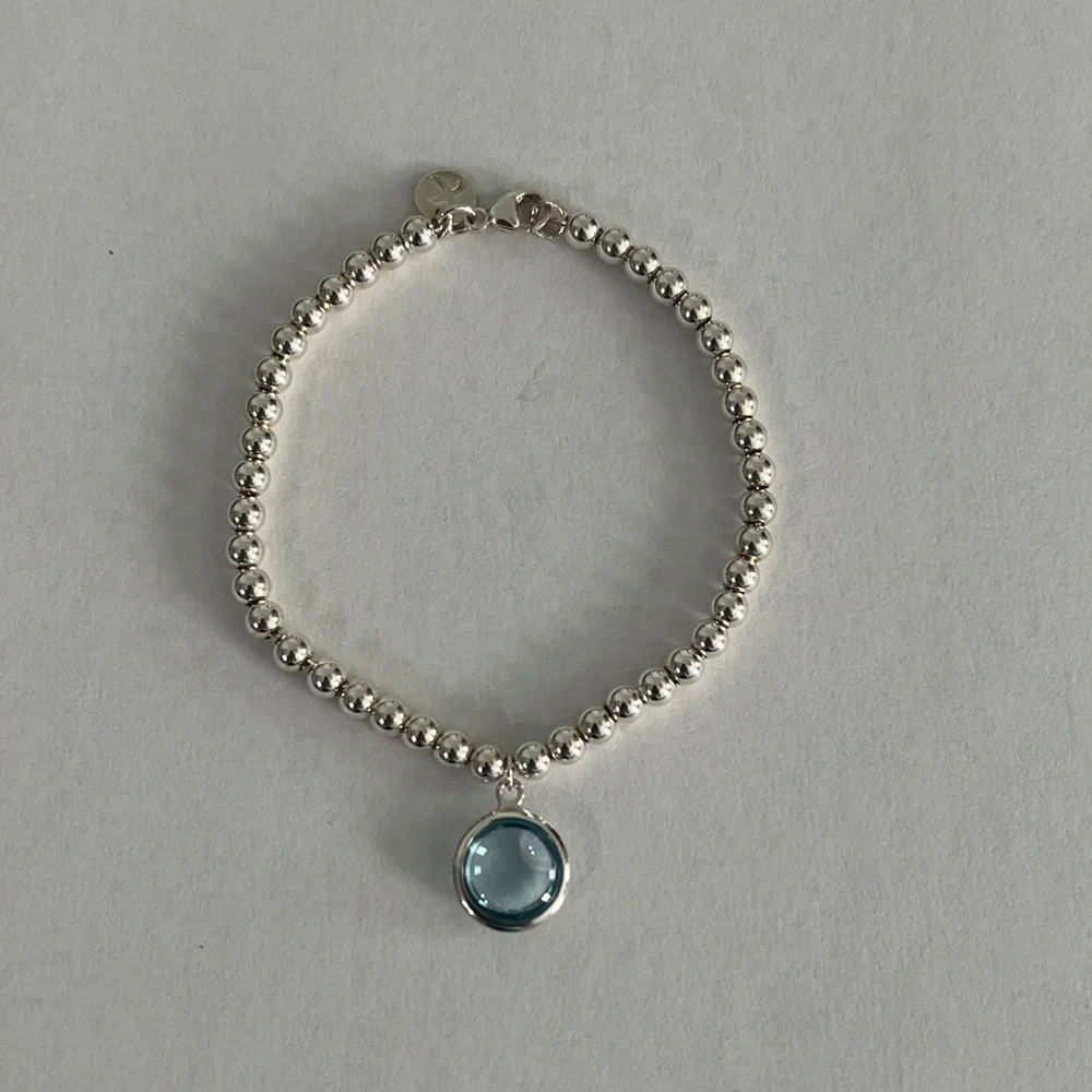 Elegant Silver Beaded Bracelet with Blue Charm
